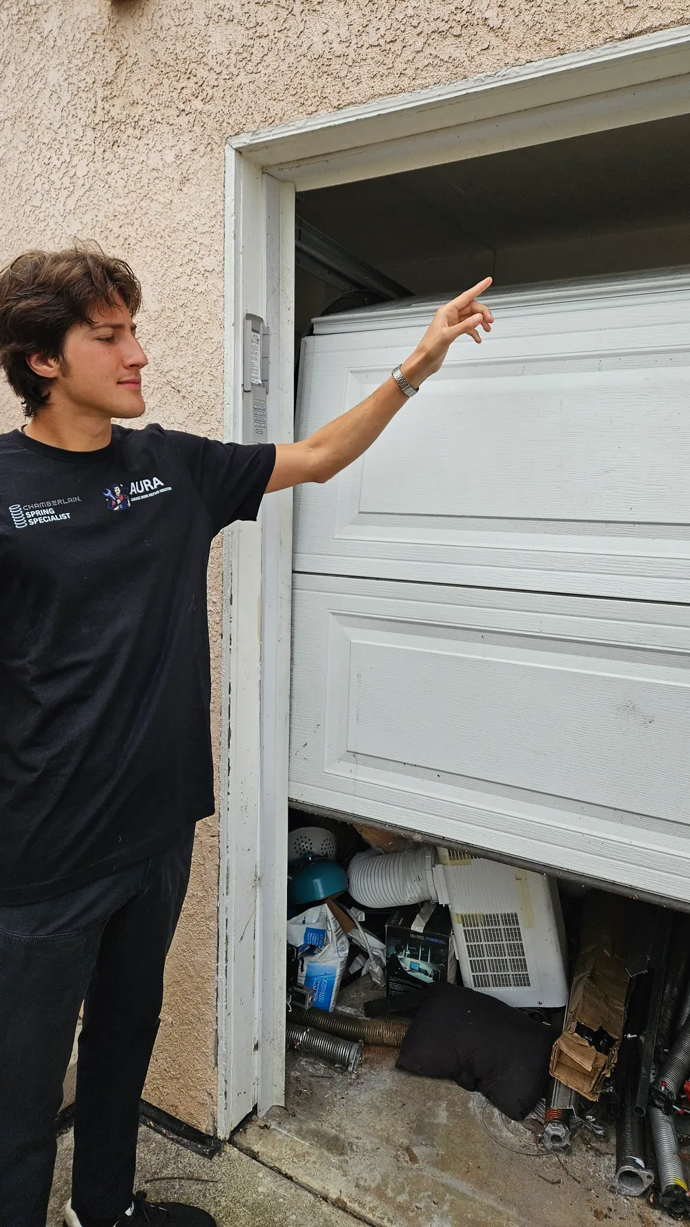 Technician pointing out an off-track door