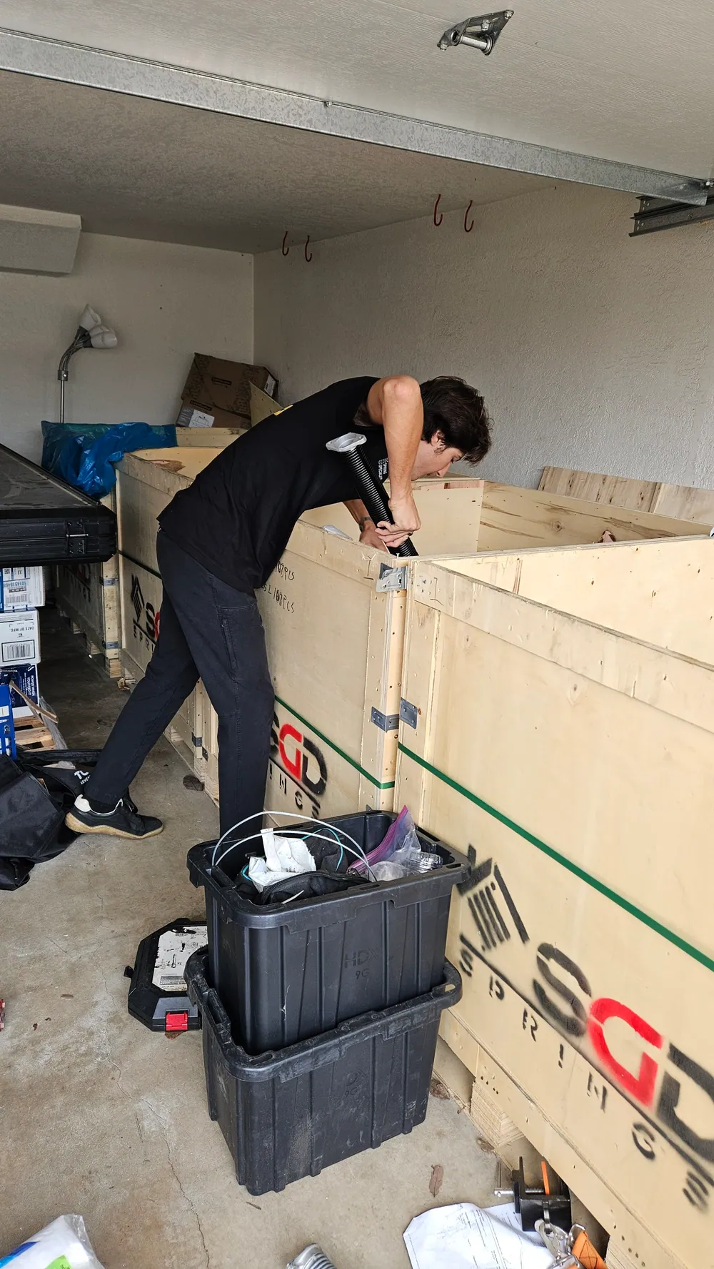 Aura technician working with a torsion tube inside a garage